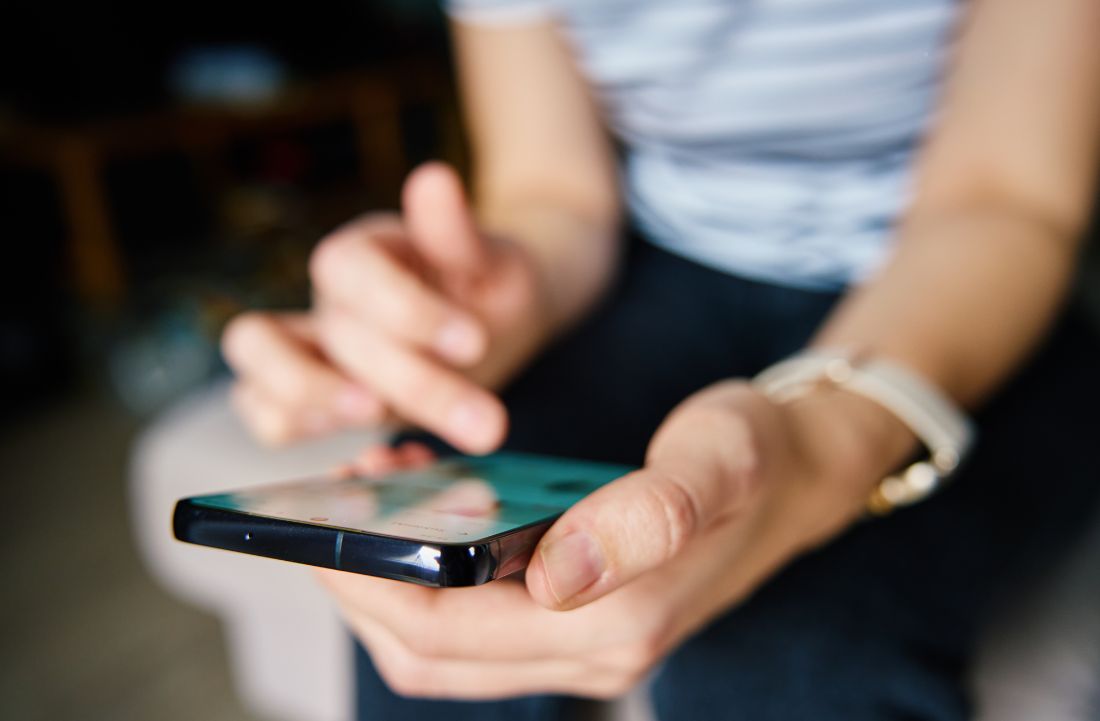 Person scrolling on cell phone