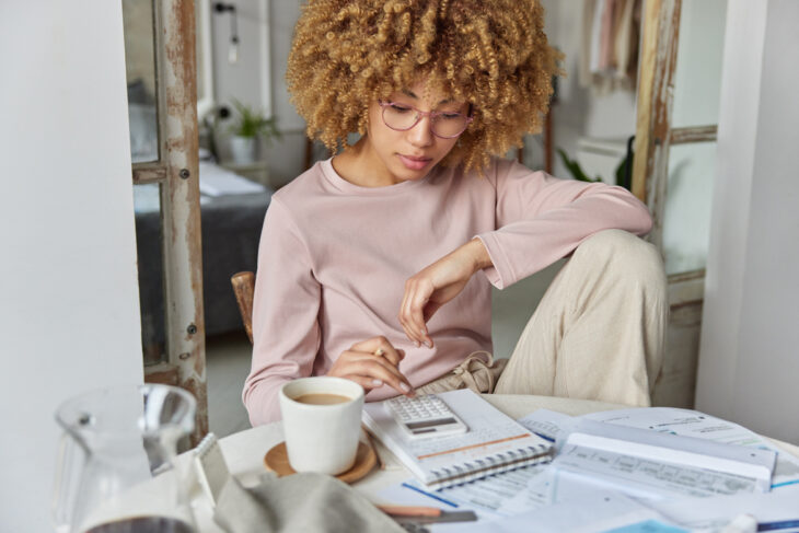 woman looking at calculator