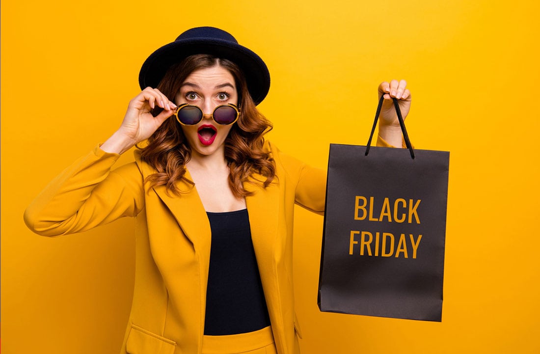 Woman looking shocked, holding a shopping bag