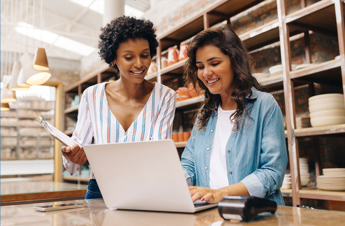 Two business owners looking at a laptop