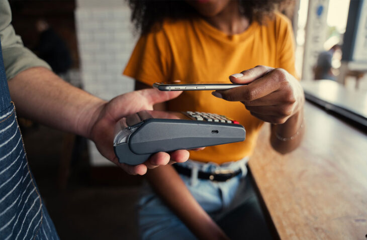 Mujer usando billetera digital para realizar un pago.