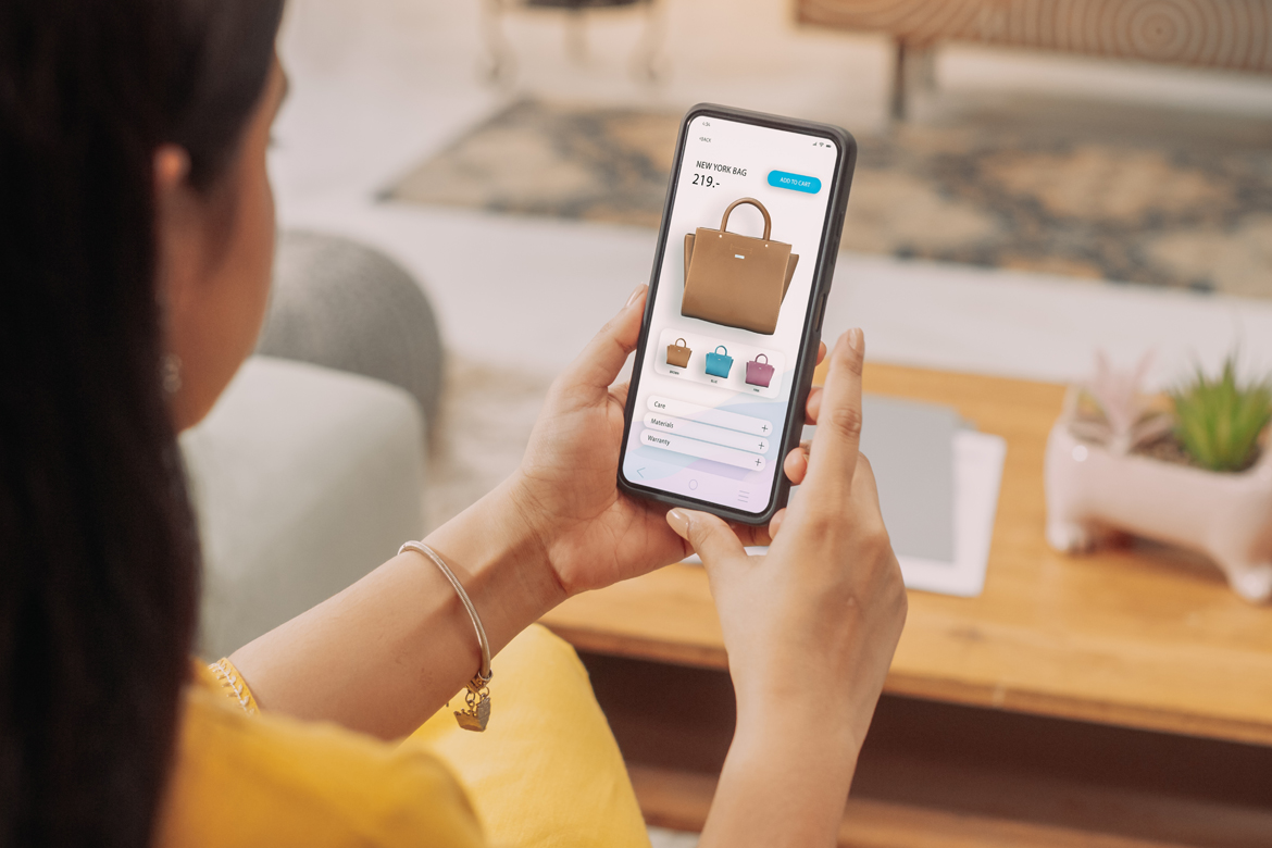 Person online shopping via a mobile device for purses.