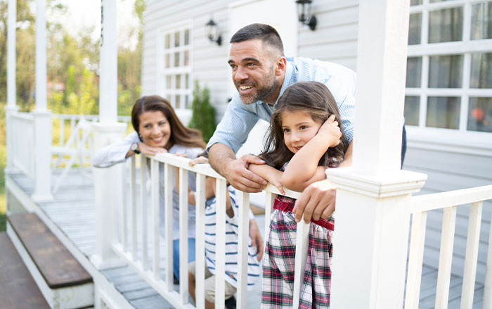 Father with two daughters standing on porch