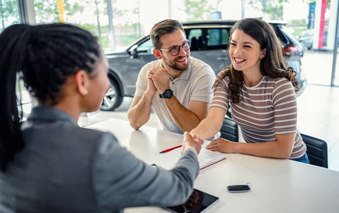 Couple making a deal at a dealership