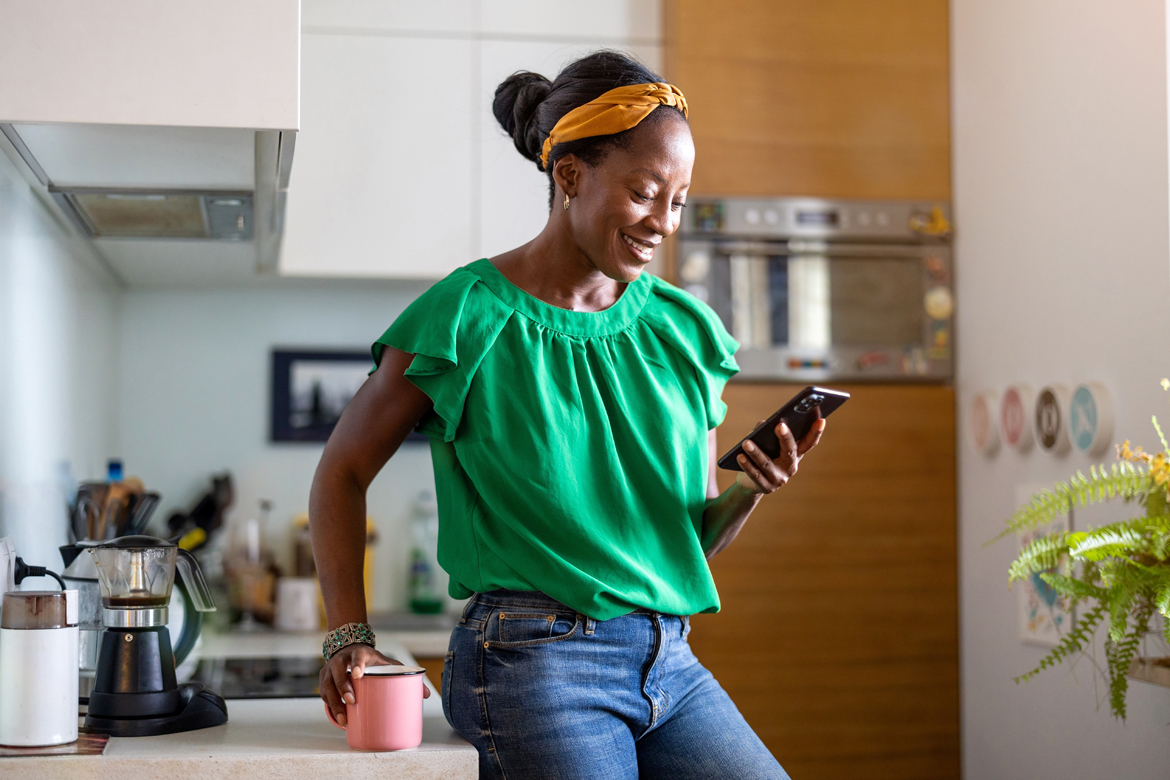 woman smiling and looking at phone