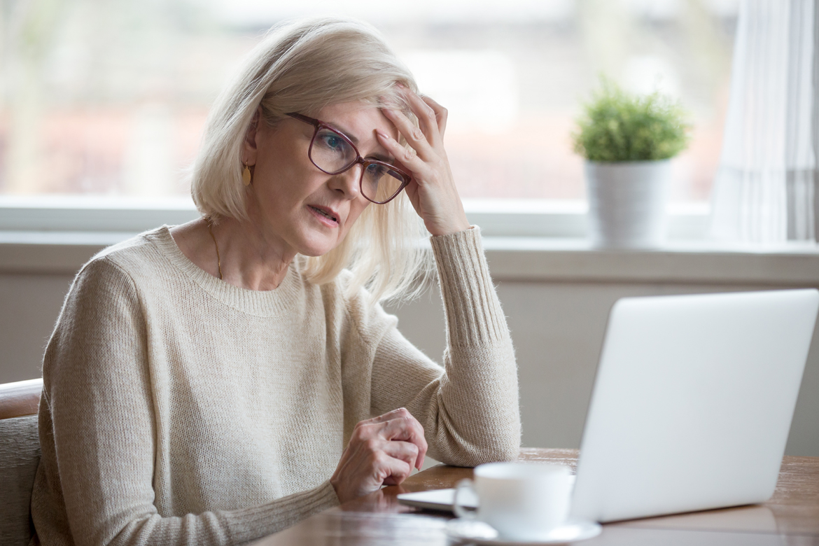 Frustrated woman looking at computer