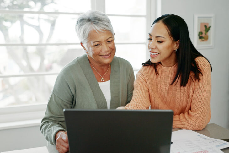 Daughter and mother looking at computer.