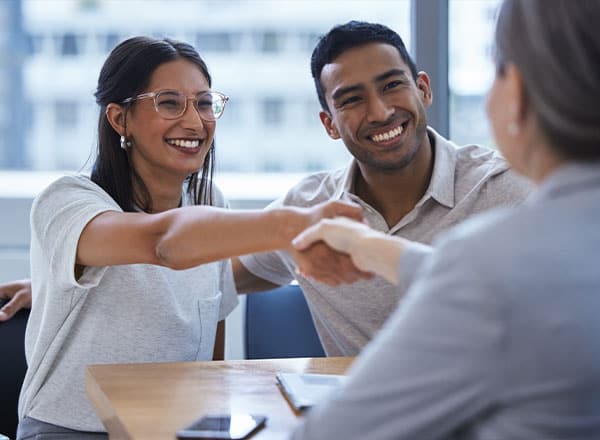 couple shaking hands with a consultant