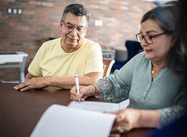 couple signing a paper