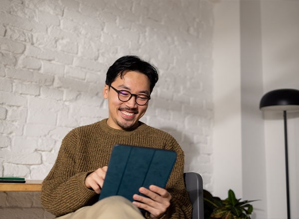 man smiling at tablet