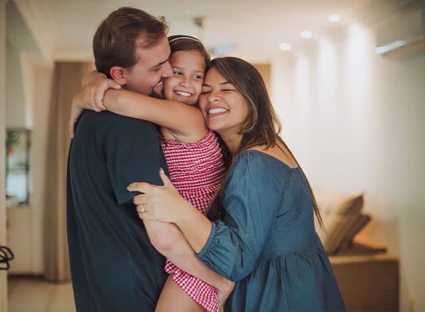 Family of three hugging