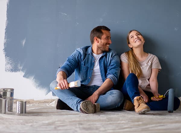 Couple painting a wall