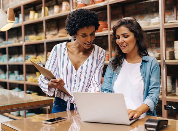 Two business owners looking at a laptop