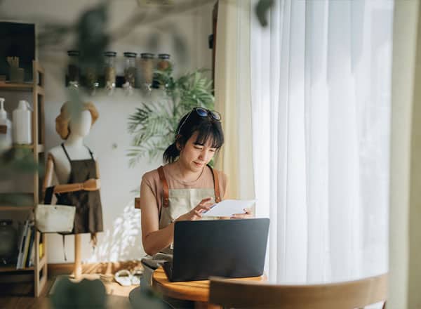 business owner looking at statement and computer