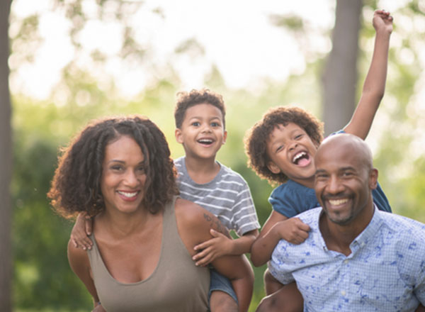 excited family of four outdoors