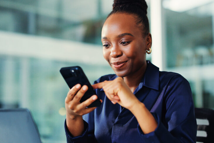 Woman looking at her phone pleasantly