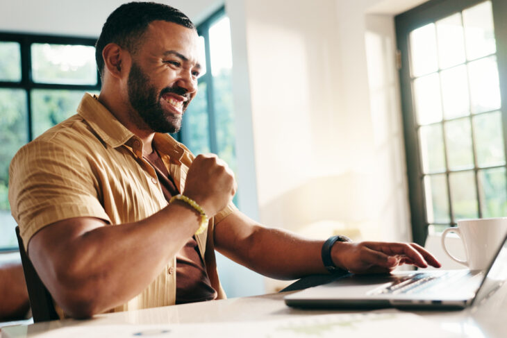 Man Smiling at Computer