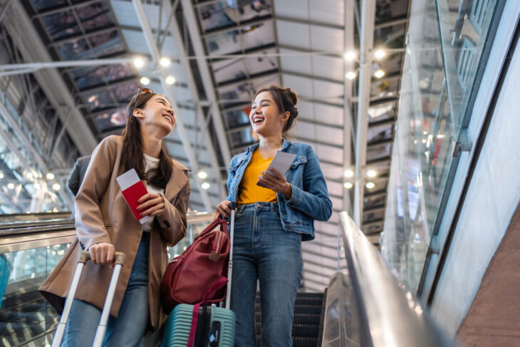 Two travelers on escalator