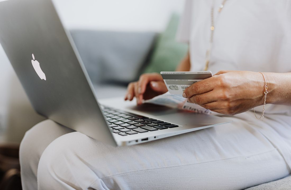 Person using their card to complete an online purchase