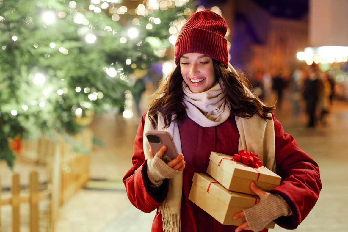 Girl looking at her phone shopping in winter